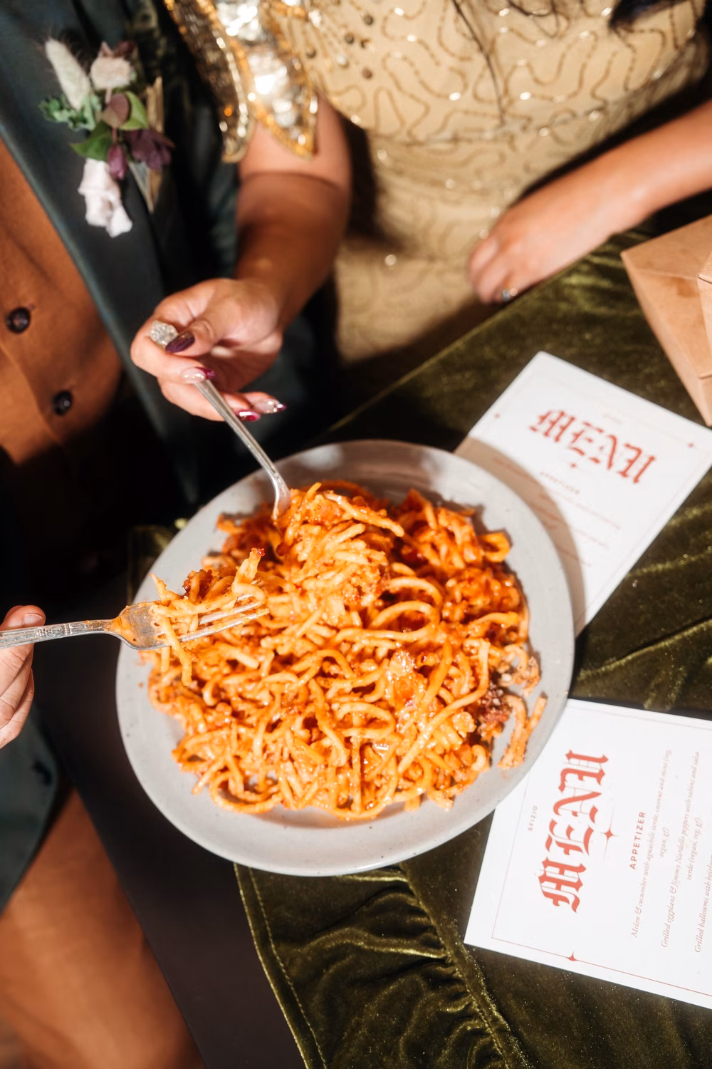 people eating pasta bolognese at a wedding