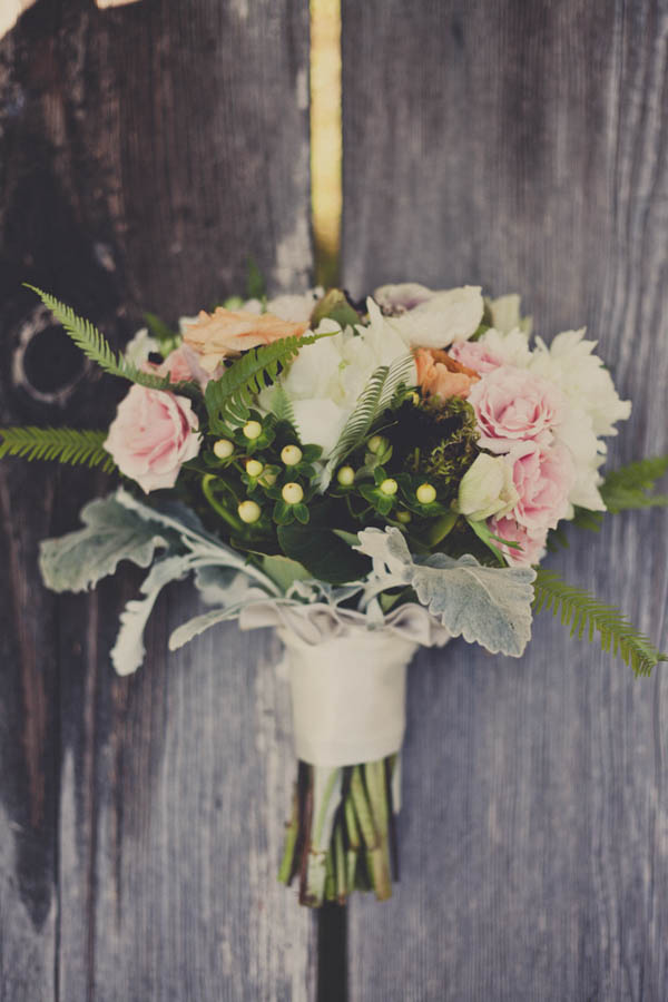 romantic camp wedding bouquet by Three Stems Flower Studio, photo by Terra Lange Photography | via junebugweddings.com romantic light pink, ivory, and orange bouquet