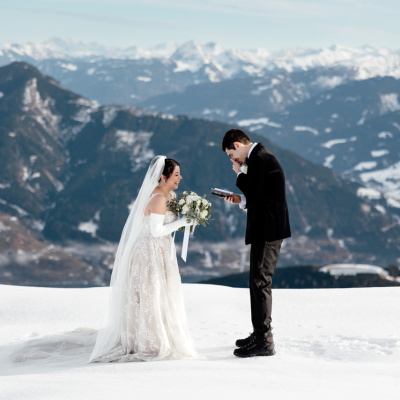 Snowy engagement photo in the mountains of Austria