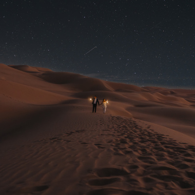 Adventurous nighttime elopement photo under the stars in Imperial Sand Dunes, California
