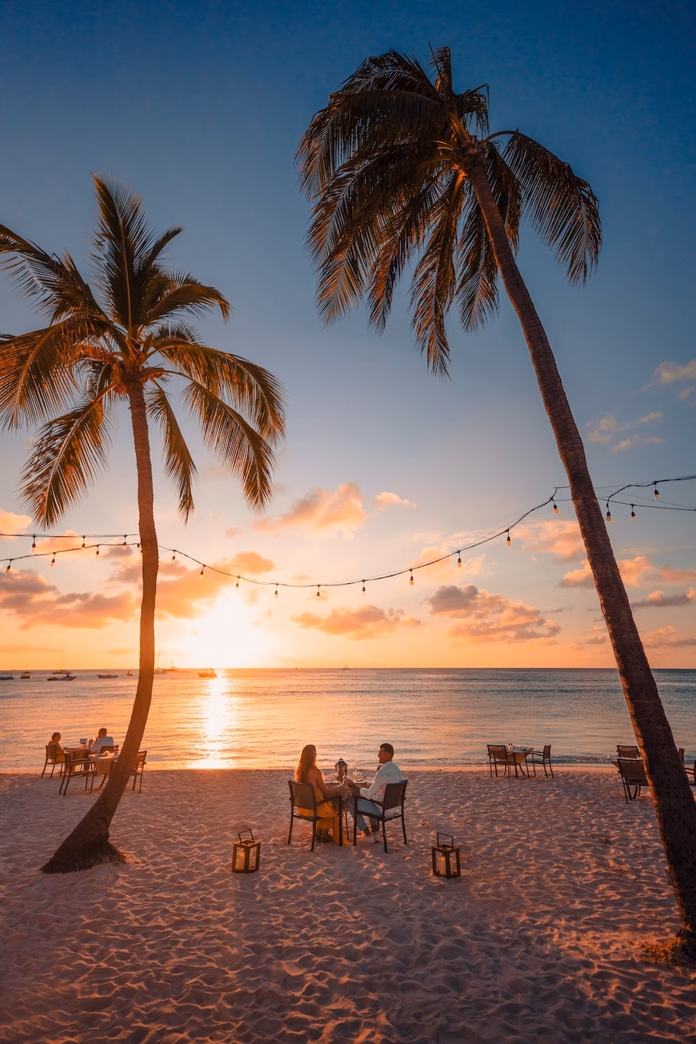 couple eating on the beach at sunset