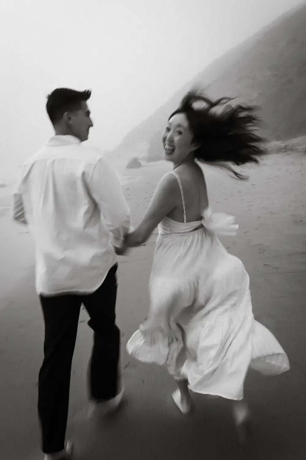happy couple running on beach