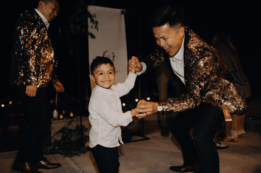 groom dancing with child