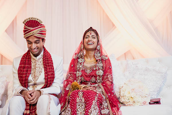 traditional Indian wedding couple laughing traditional Indian wedding couple laughing
