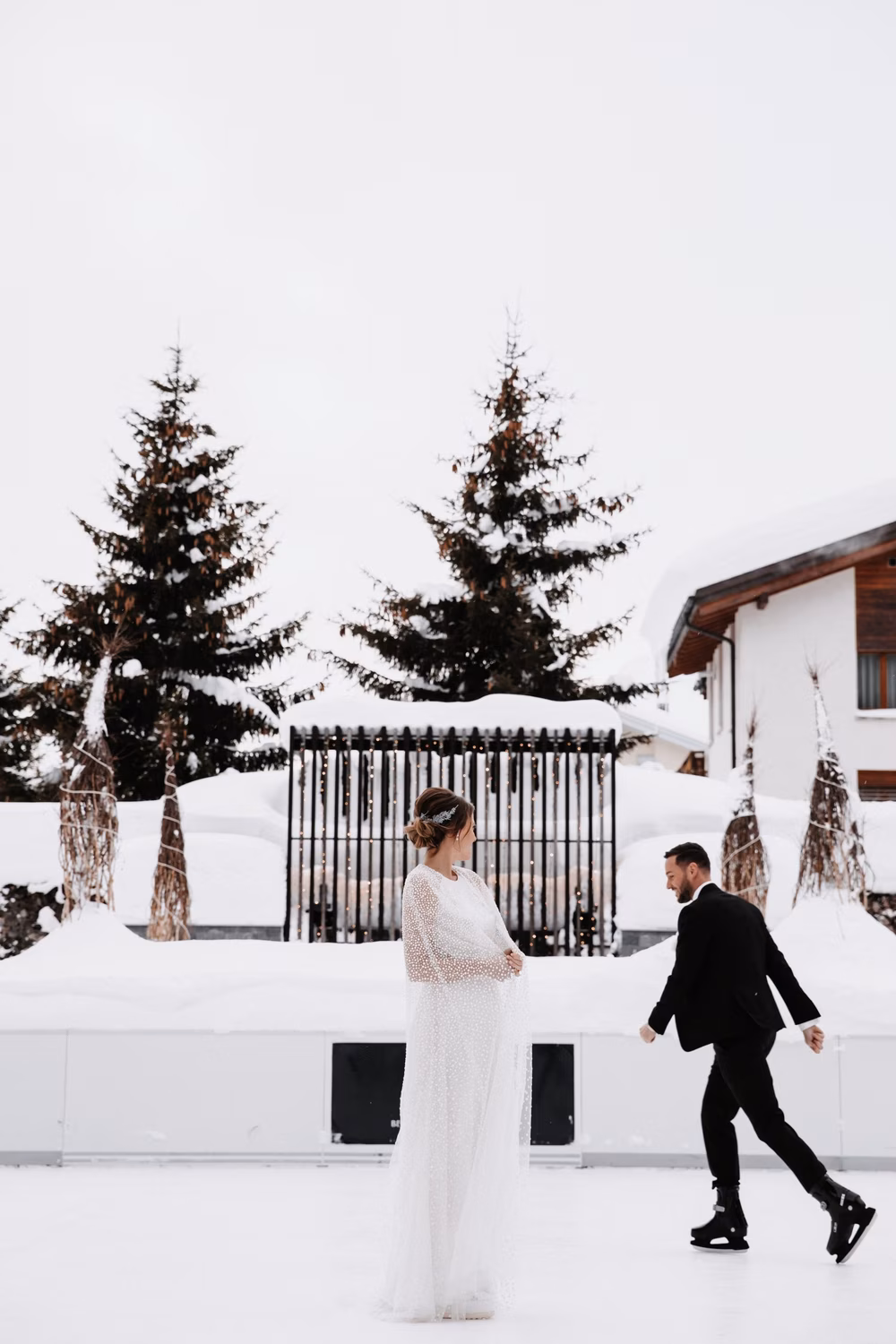couple ice skating on wedding day