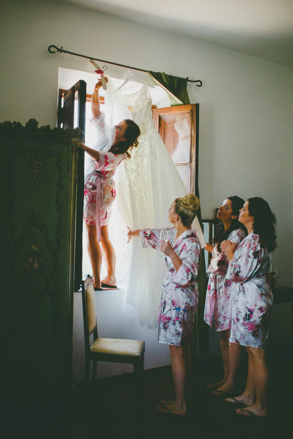 bride and bridesmaids getting the dress bride and bridesmaids getting the dress