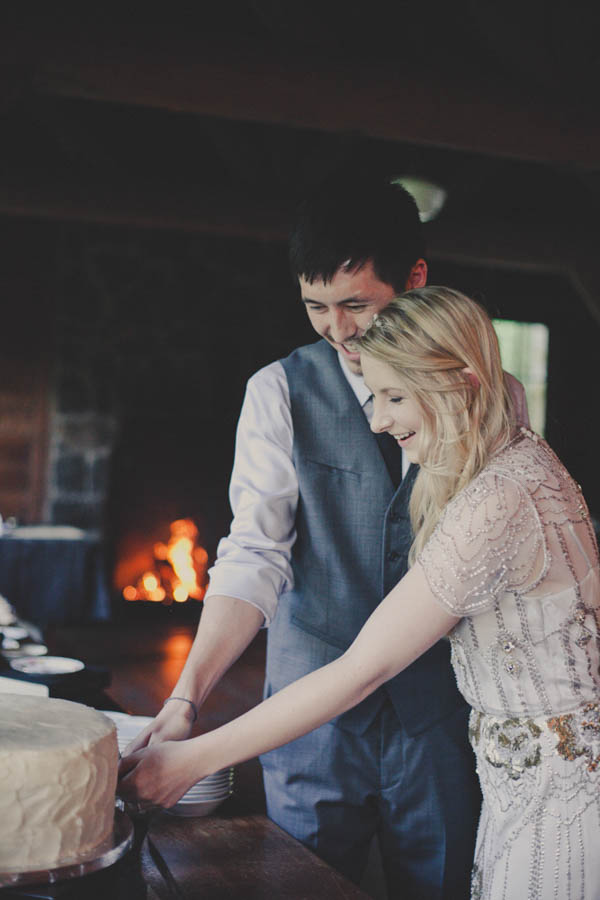 romantic camp wedding reception, photo by Terra Lange Photography | via junebugweddings.com couple cutting the cake