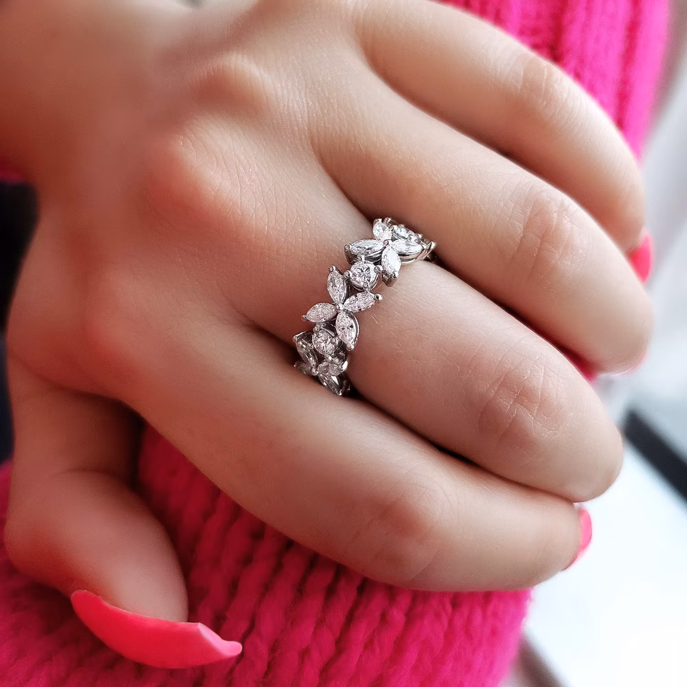 woman wearing round and marquise diamond eternity band
