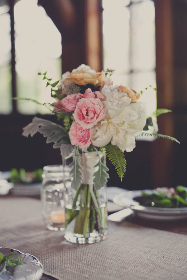 romantic camp wedding reception flowers, photo by Terra Lange Photography | via junebugweddings.com romantic light pink, orange, and ivory wedding reception flowers
