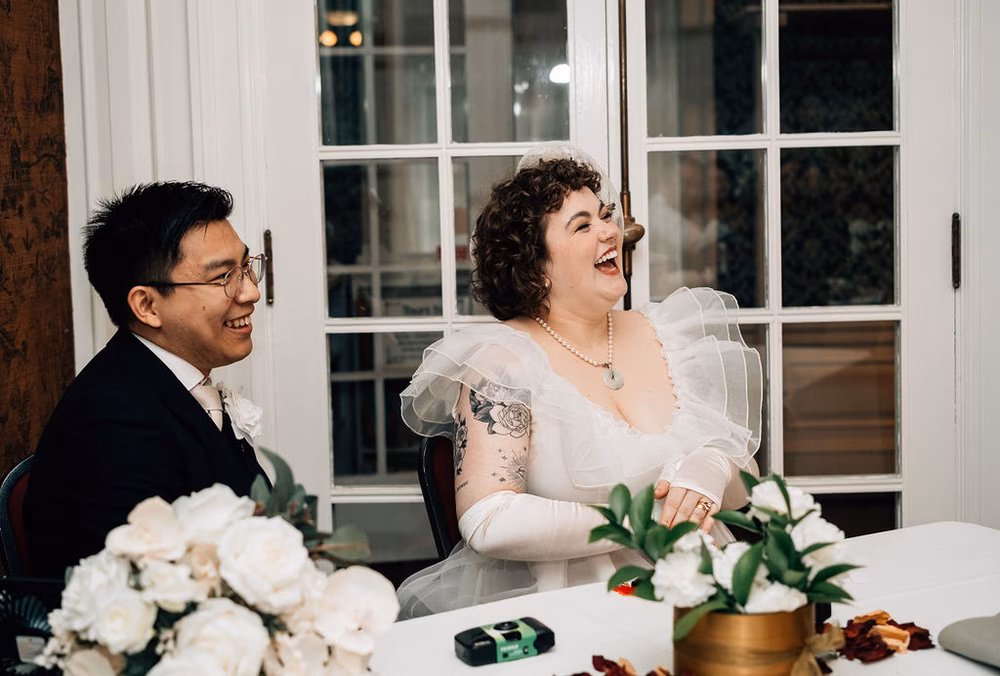 bride and groom listening to speeches