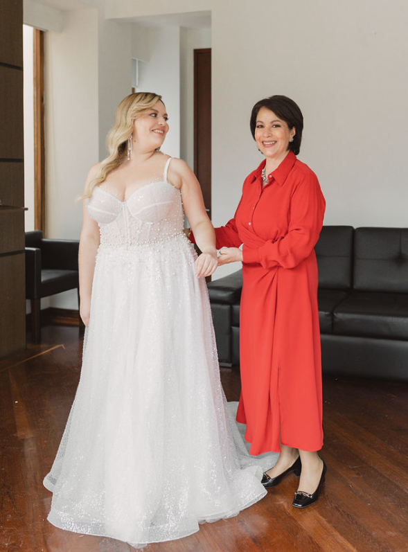 mother of the bride helping bride get ready