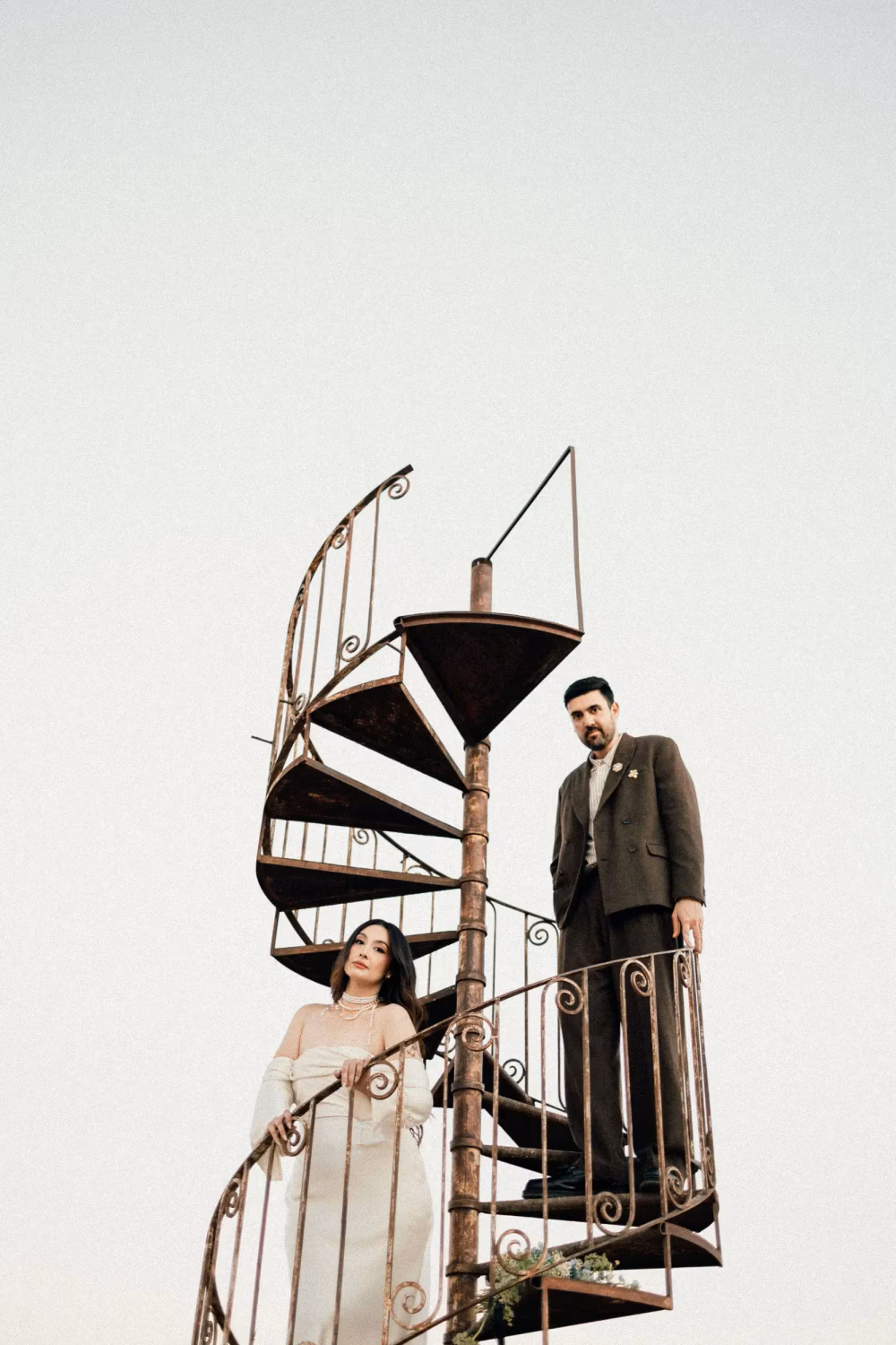 couple on floating spiral staircase