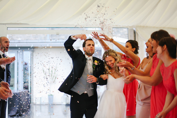 couple's confetti entrance, photo by Sansom Photography | via junebugweddings.com couple's confetti entrance, photo by Sansom Photography | via junebugweddings.com