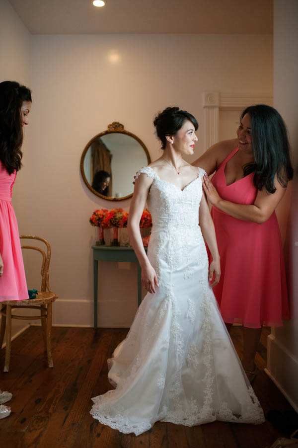 bride getting into her wedding dress bride getting into her wedding dress
